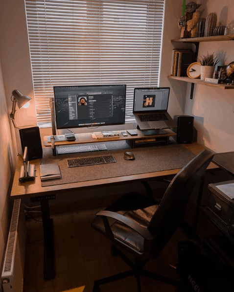 shows a home office setup with monitor, laptop and desk and chair