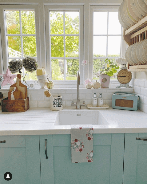 a country style kitchen in a soft green color
