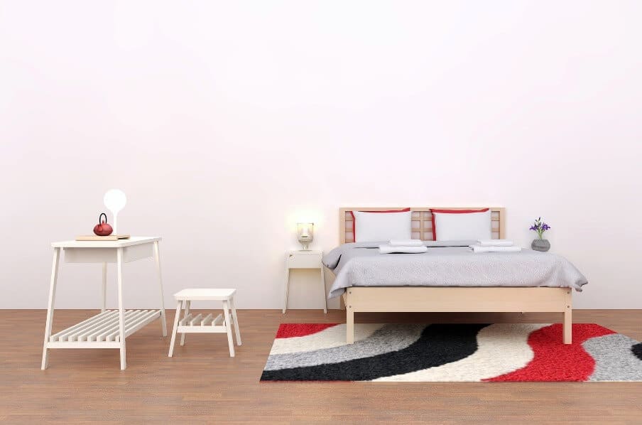 bed and side table sitting on an area rug with bold colors
