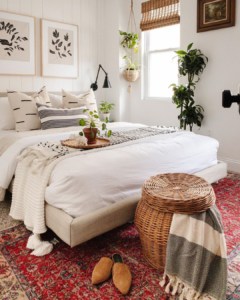 White bedroom with rug and wicker basket