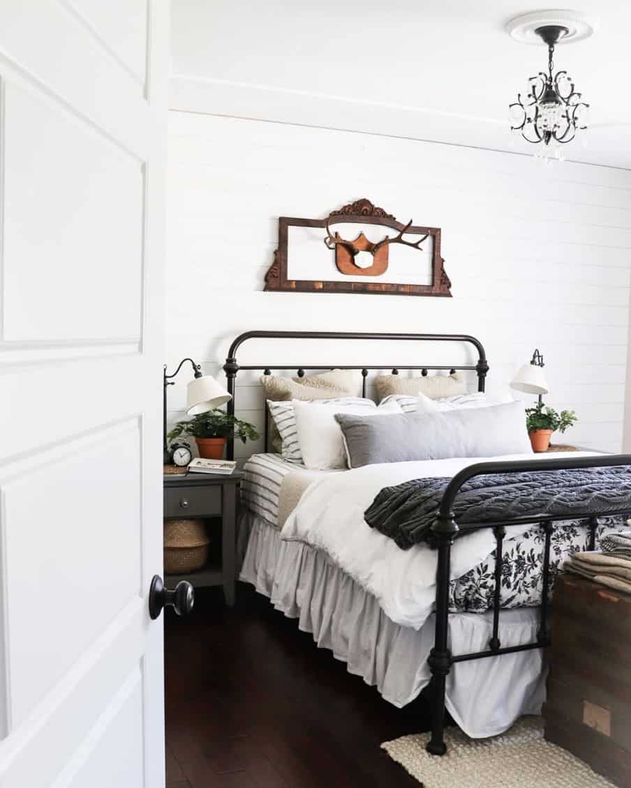 mostly white colored bedroom with a purple throw at the end of the bed