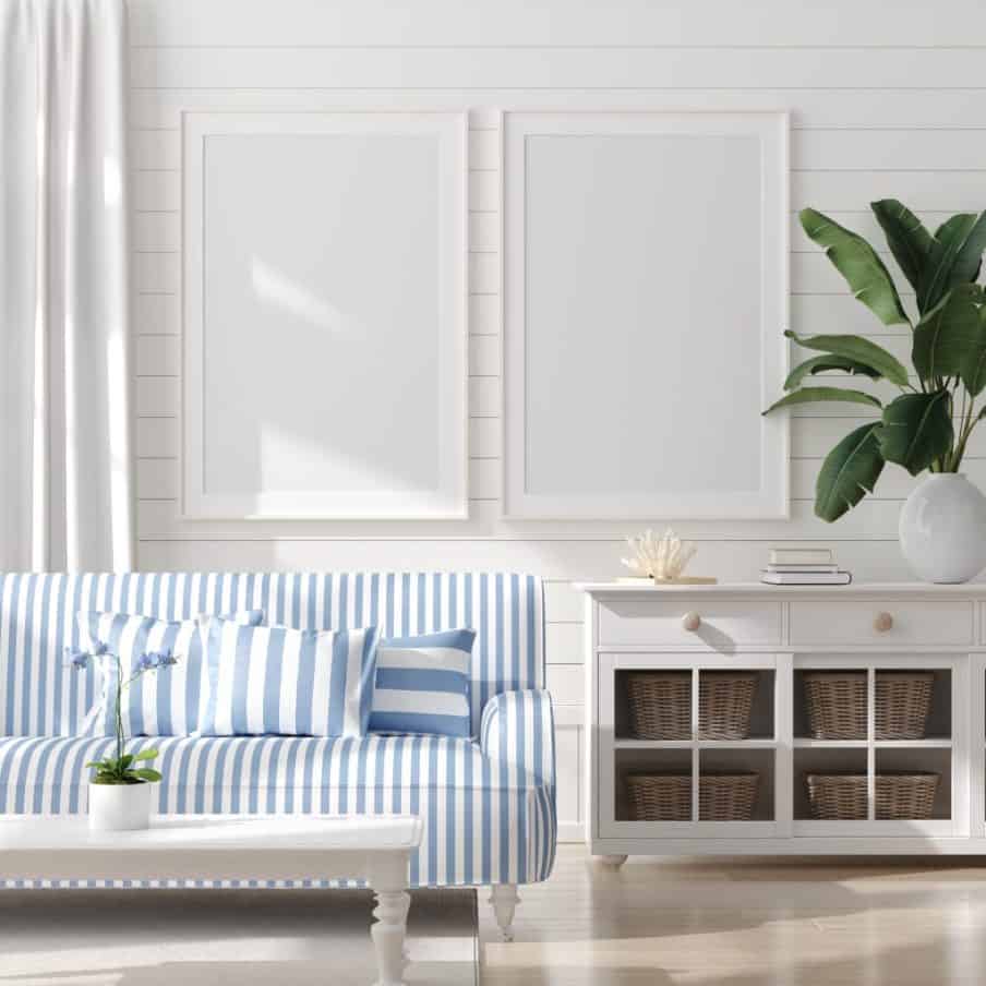 a white coastal inpired room with a blue striped sofa and cushions