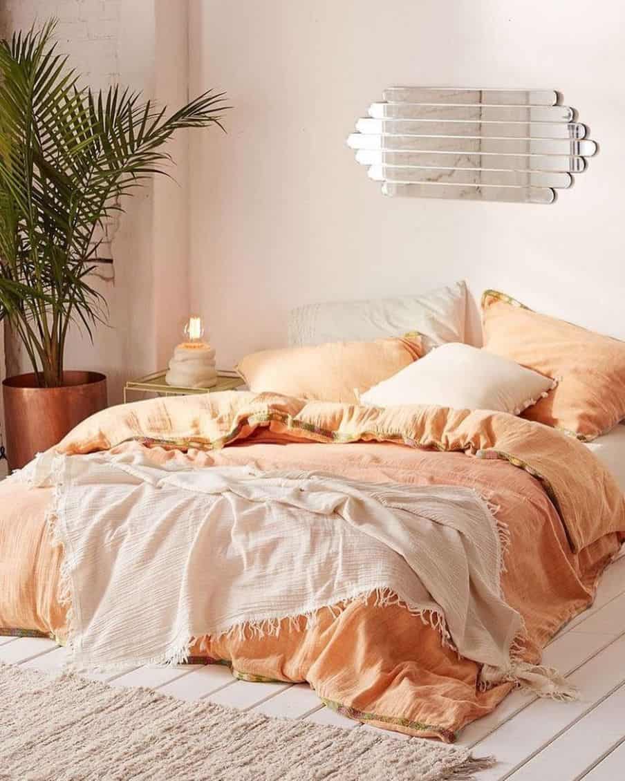 pink throw on peach colored bedding