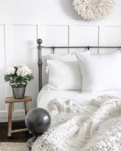 White bedroom with white bedding and throw