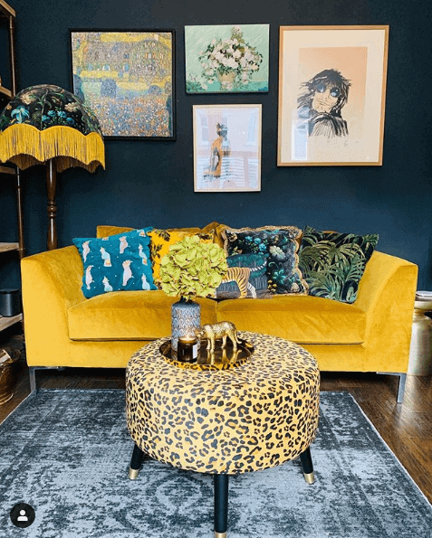 a mustard yellow sofa with cushions