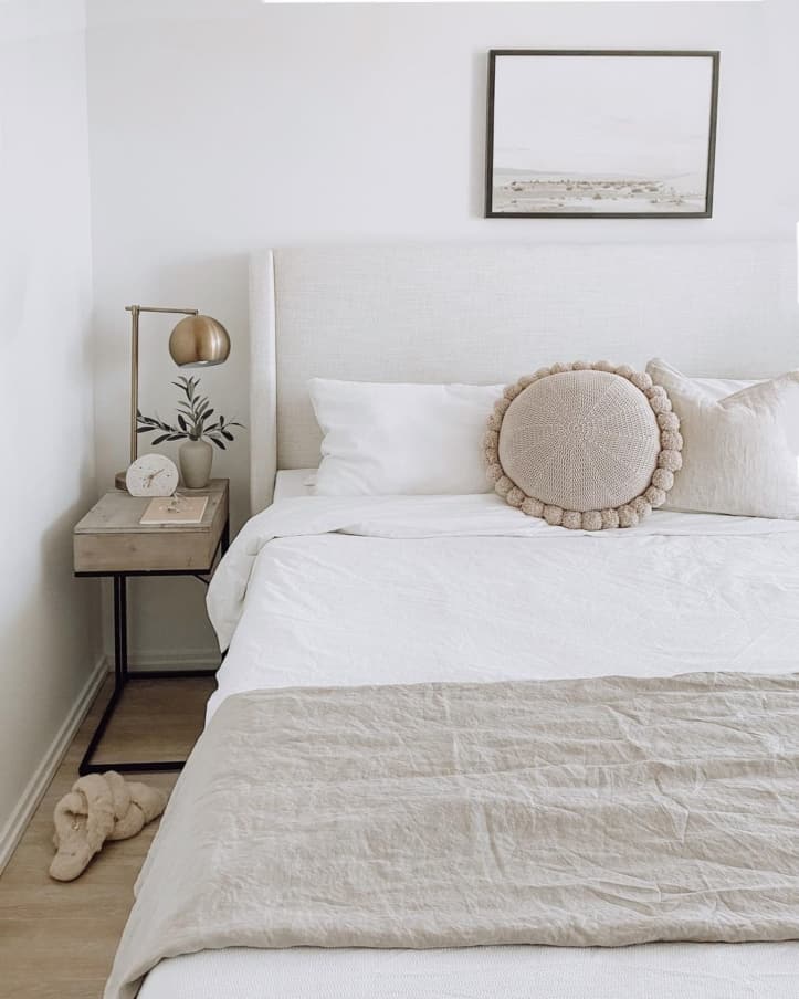 White bedroom with sand throw