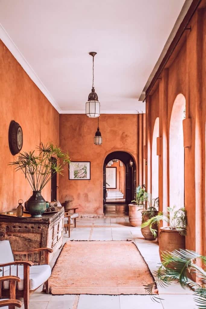 living arear with red brown wall color and arched windows