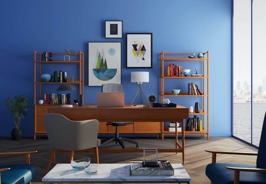 brown desk in home office with blue walls