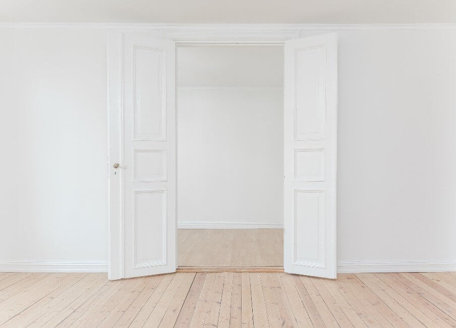 pair of white internal doors in a white wall